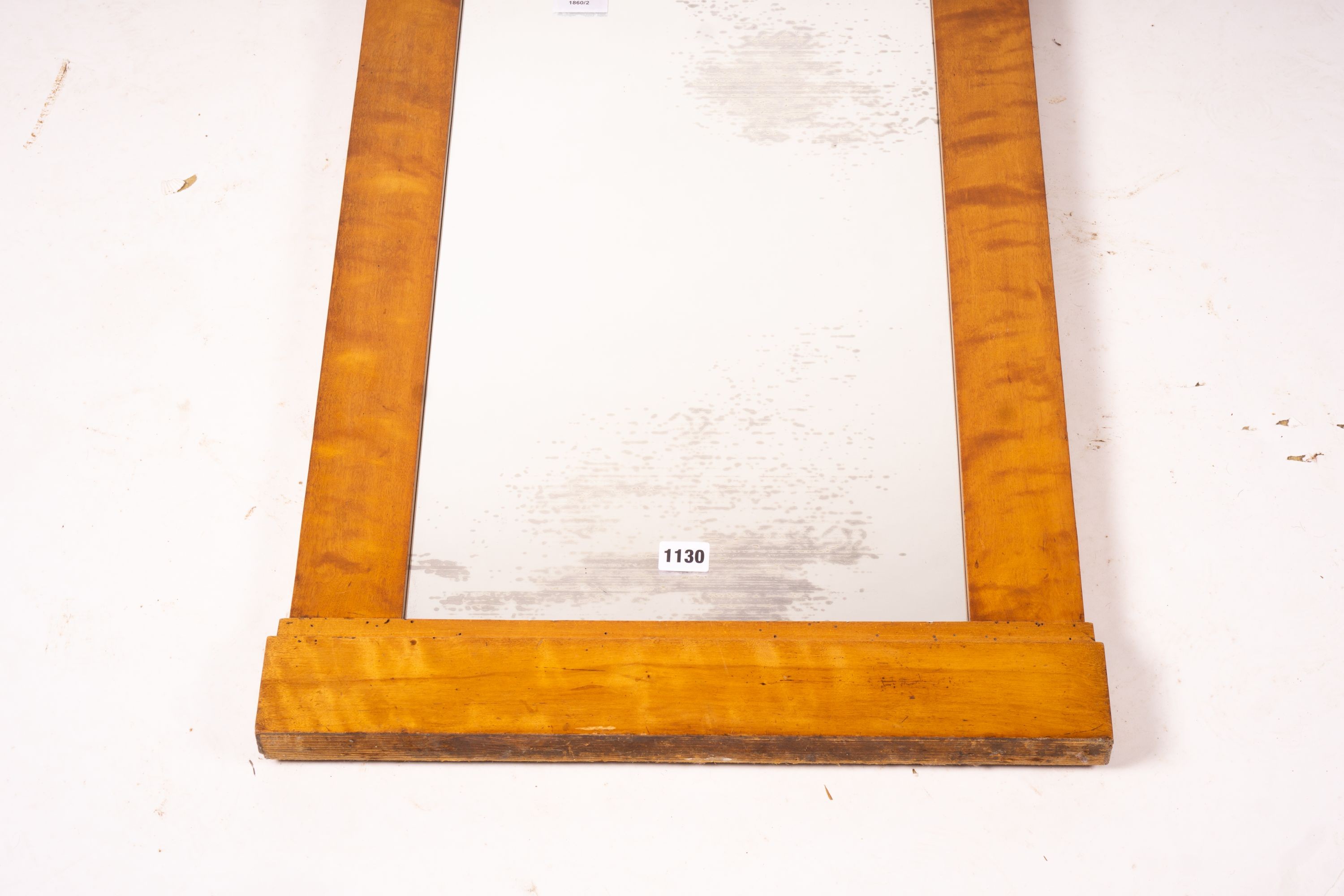 A Biedermeier style maple wall mirror, width 52cm, height 109cm